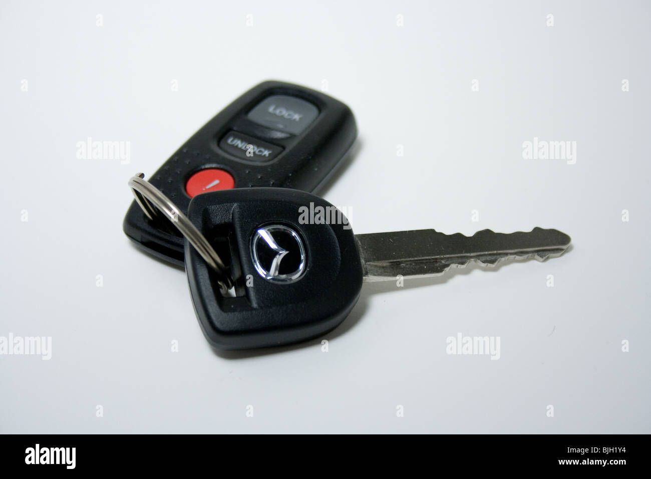 car key remote white background isolated panic lock unlock mazda Japanese import sales Stock Photo