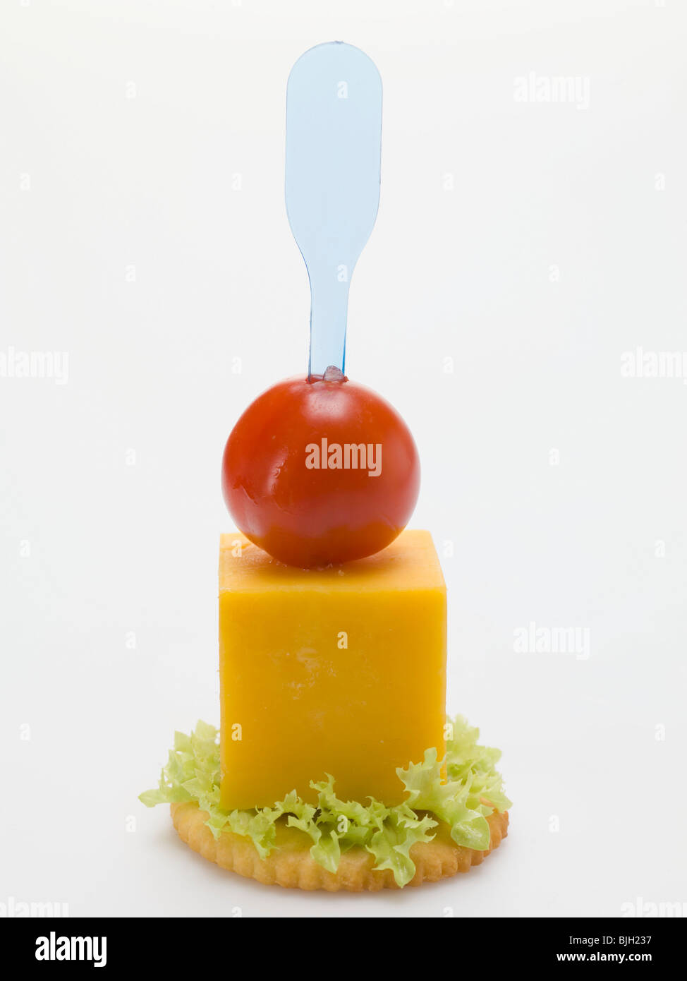 Cheese and cherry tomato on cracker - Stock Photo