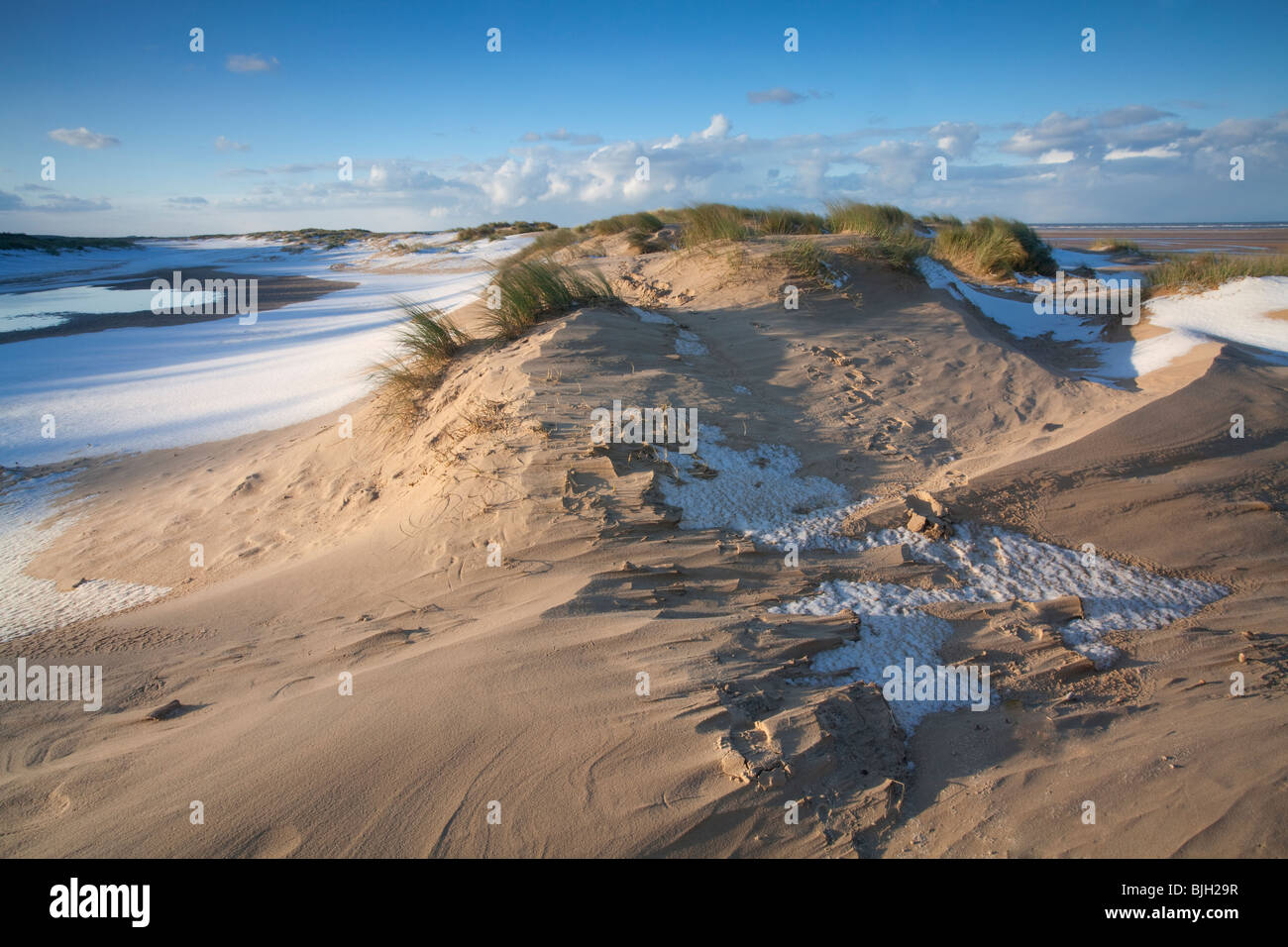Winter snow on the beach and sand dunes at Holkham Bay on the North Norfolk Coast. Stock Photo