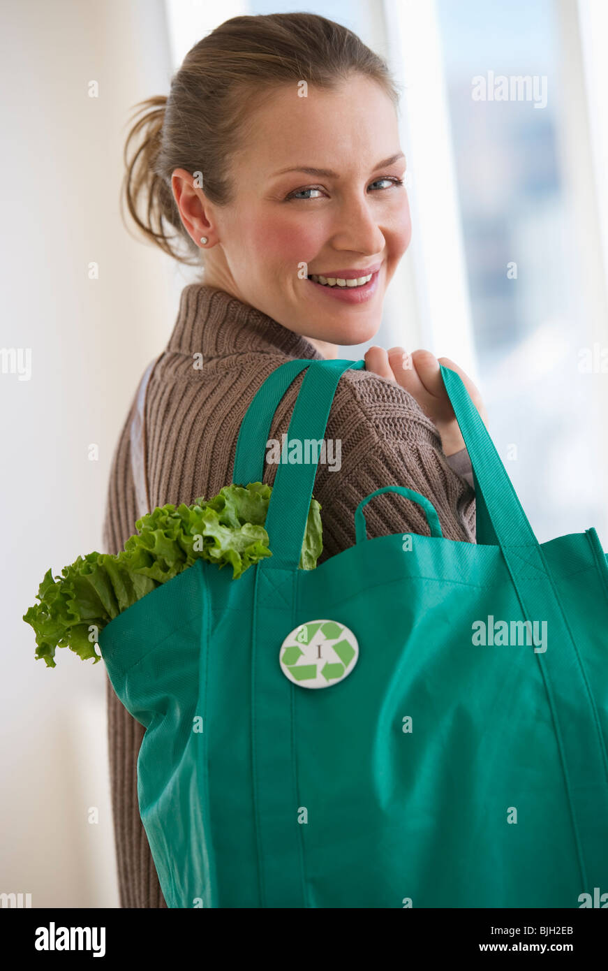 Woman carrying bag of groceries Stock Photo Alamy