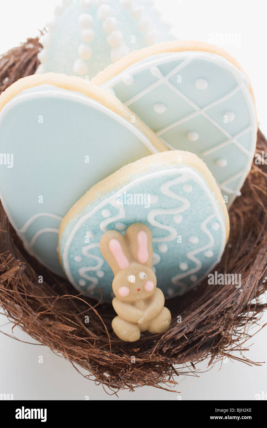 Biscuits and marzipan rabbit in Easter nest - Stock Photo