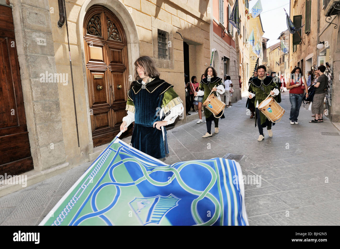 Montepulciano, Tuscany, Italy. Costume pageant through town streets during annual wine festival known as the Bravio delle Botti Stock Photo