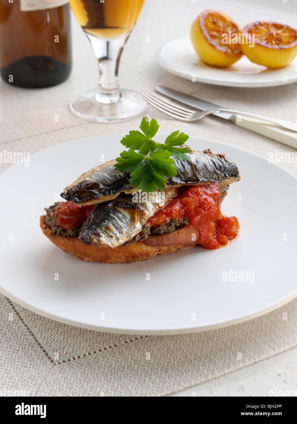 Sardine fillets on toast with a tapenade and tomato compote Stock Photo Alamy