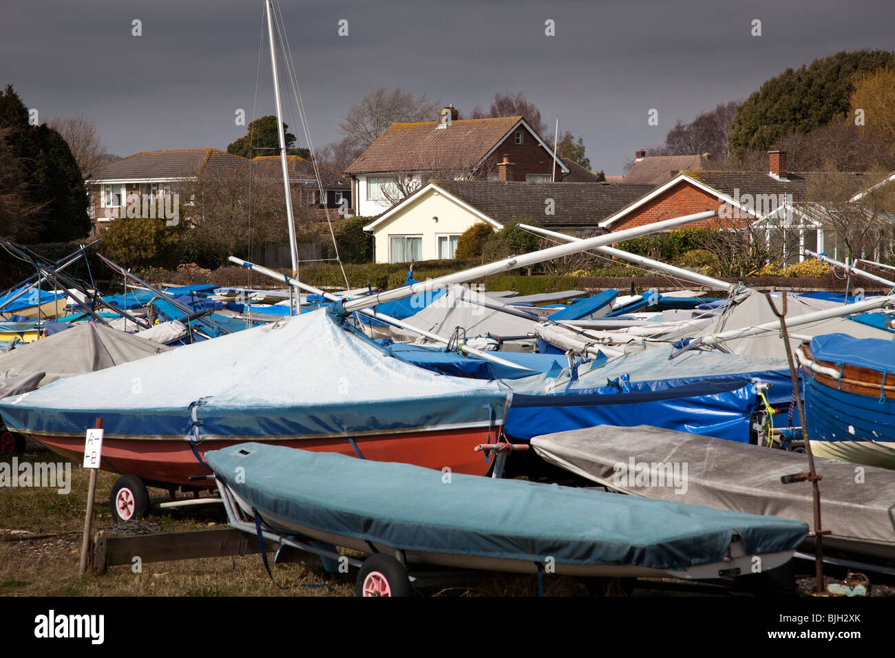 dinghy park with covered sailboats and yachts Stock Photo - Alamy