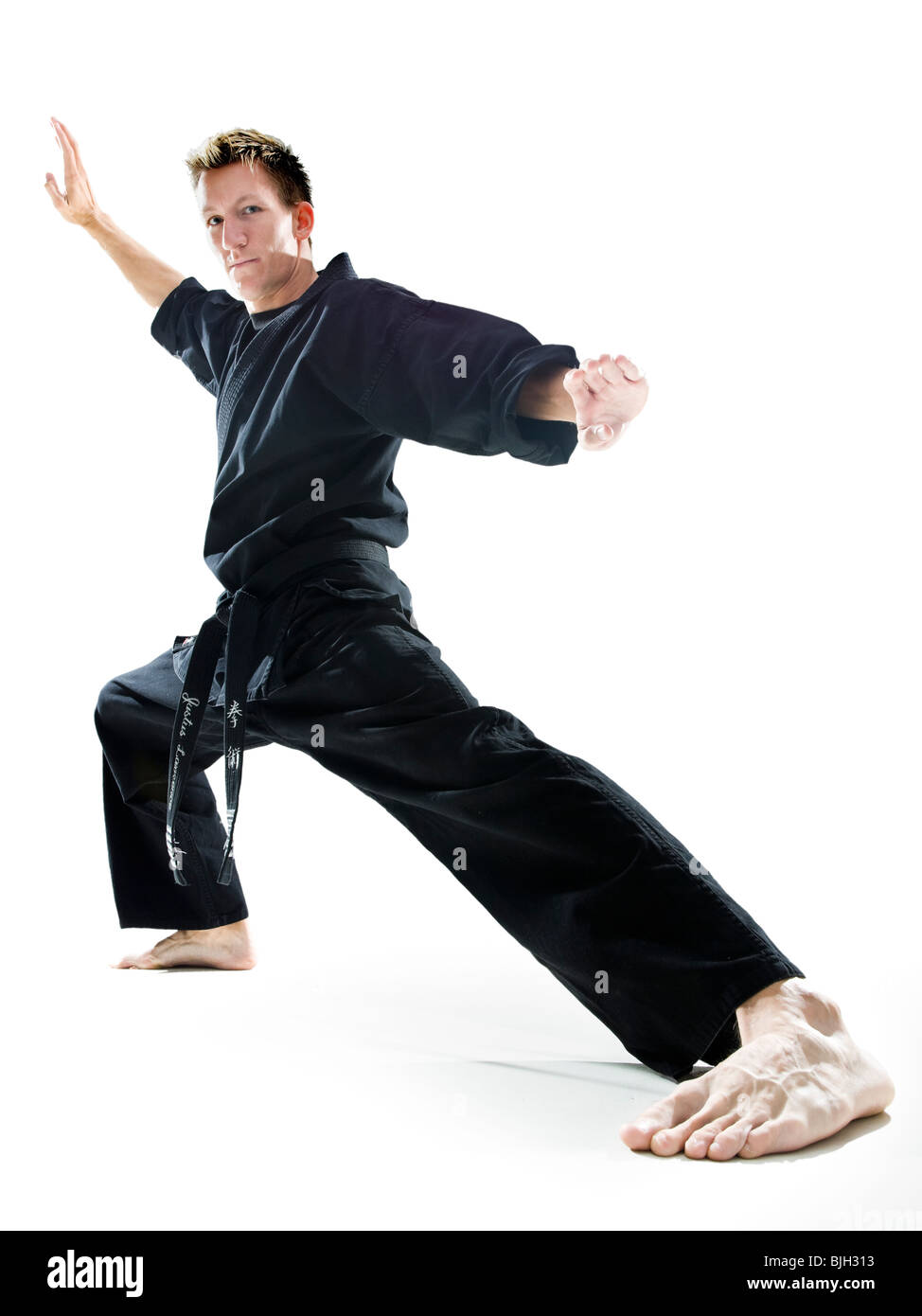 man in a black karate gi practicing martial arts Stock Photo