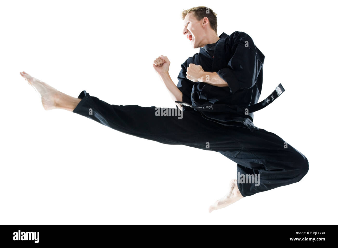 man in a black karate gi practicing martial arts Stock Photo