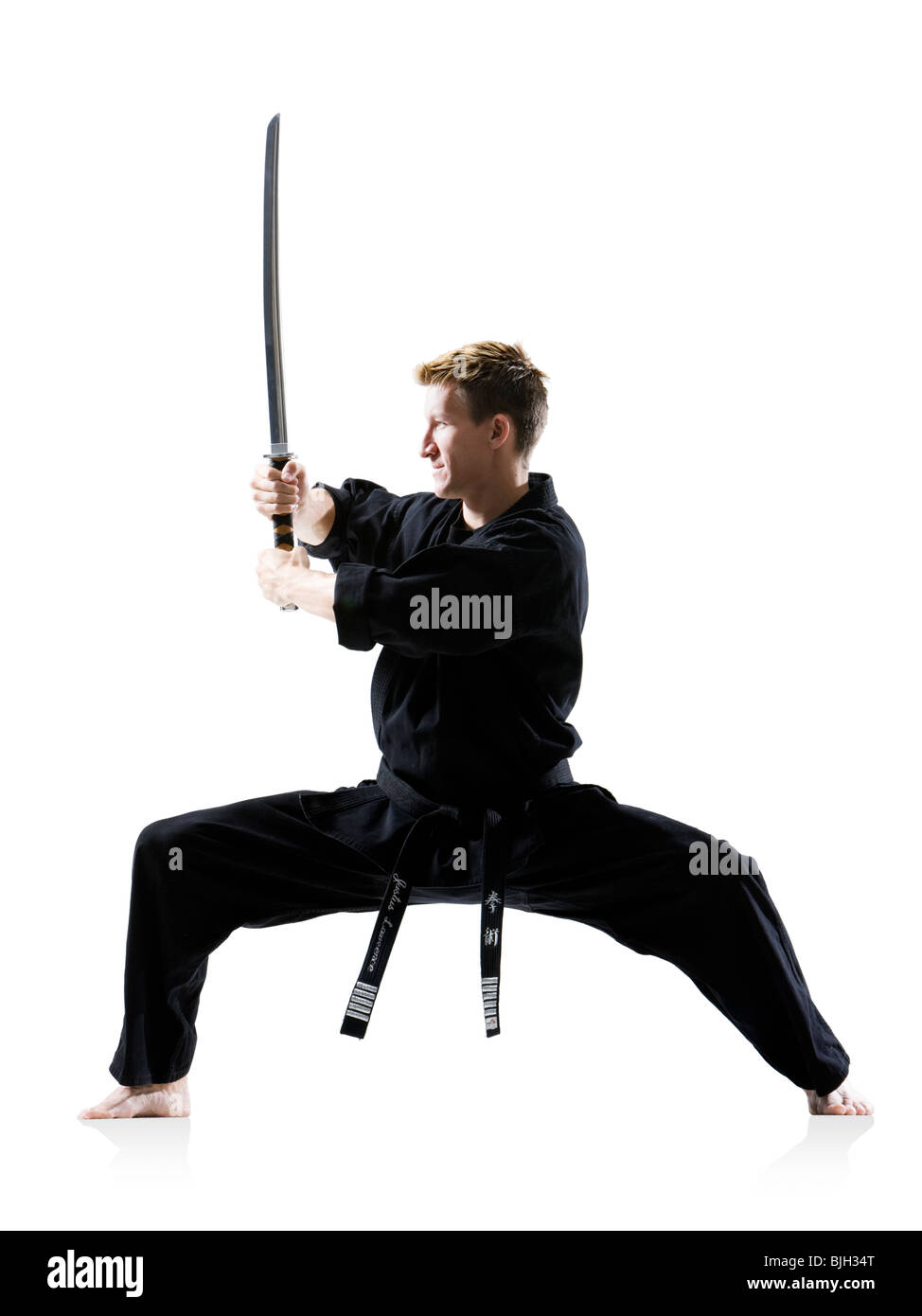 man in a black karate gi practicing martial arts Stock Photo Alamy