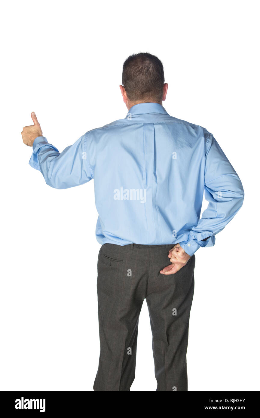 A businessman gives a thumbs up and has his fingers crossed behind his back as if lying or deceiving his clients. Stock Photo
