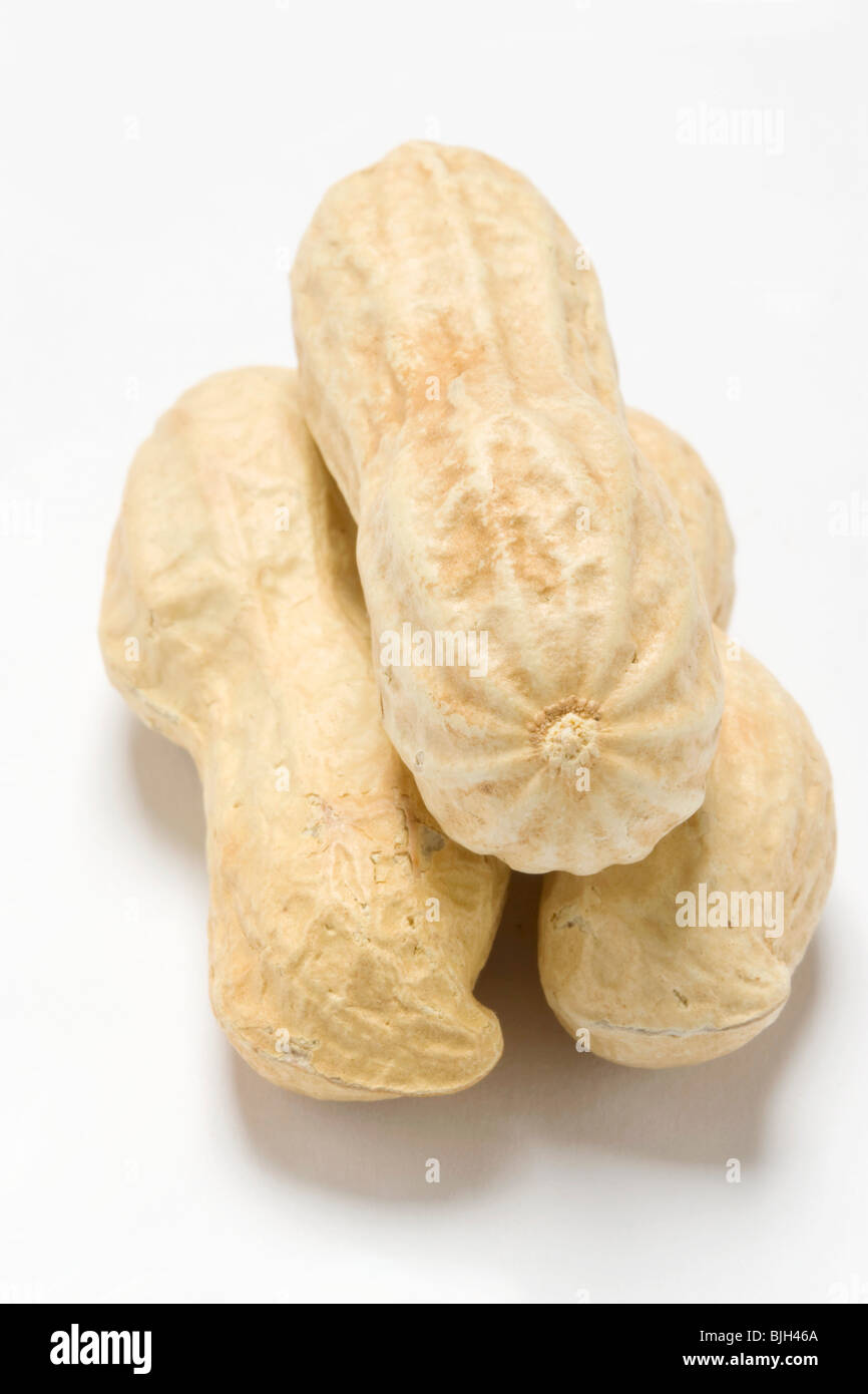 Three unshelled peanuts - Stock Photo