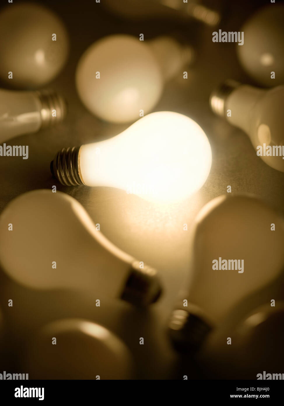 one light bulb lit up among many Stock Photo Alamy