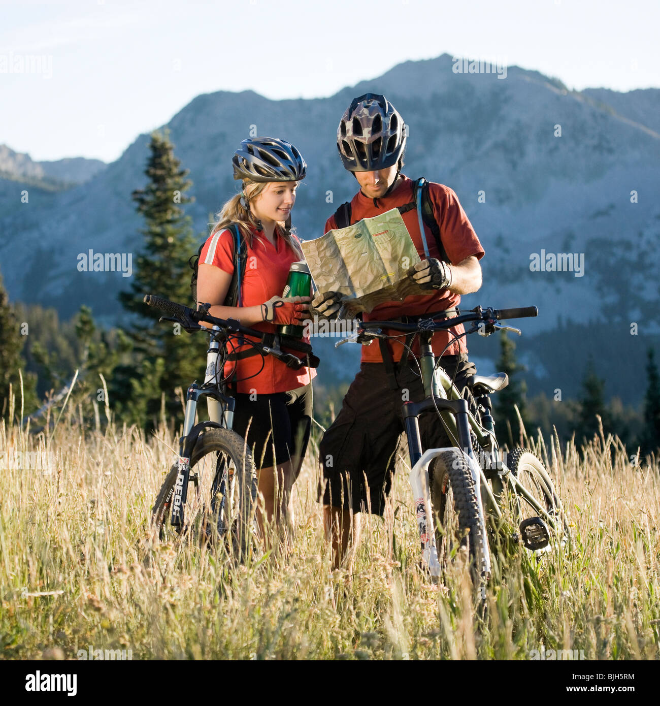 mountain bikers looking at a map Stock Photo