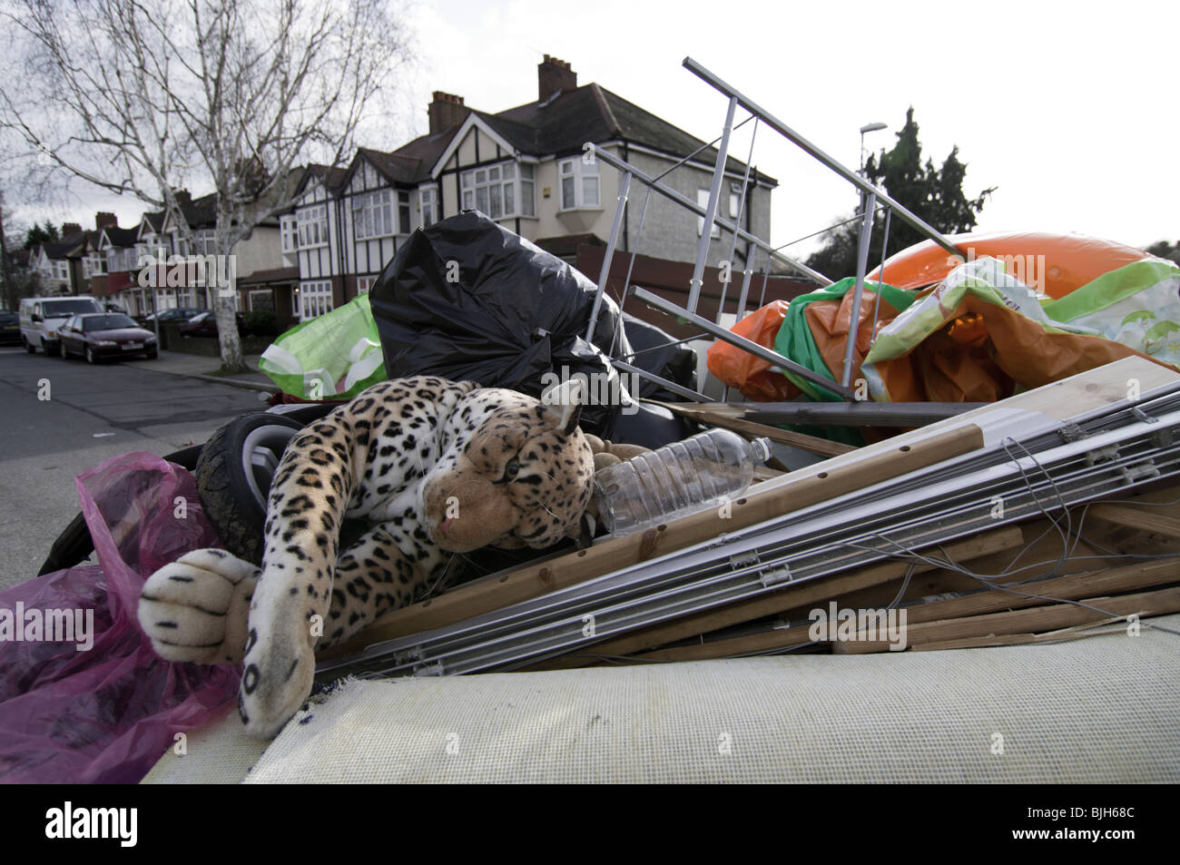 Full skip in the road ready to be taken away Stock Photo Alamy