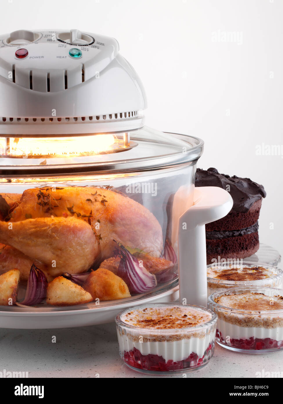 Halogen oven with chicken cooking Stock Photo Alamy