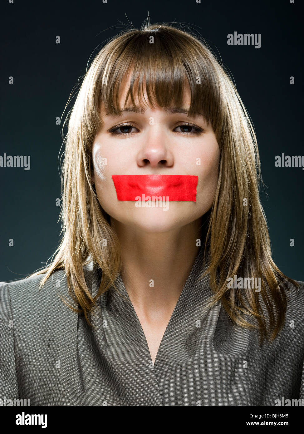 businesswoman with red tape over her mouth Stock Photo Alamy