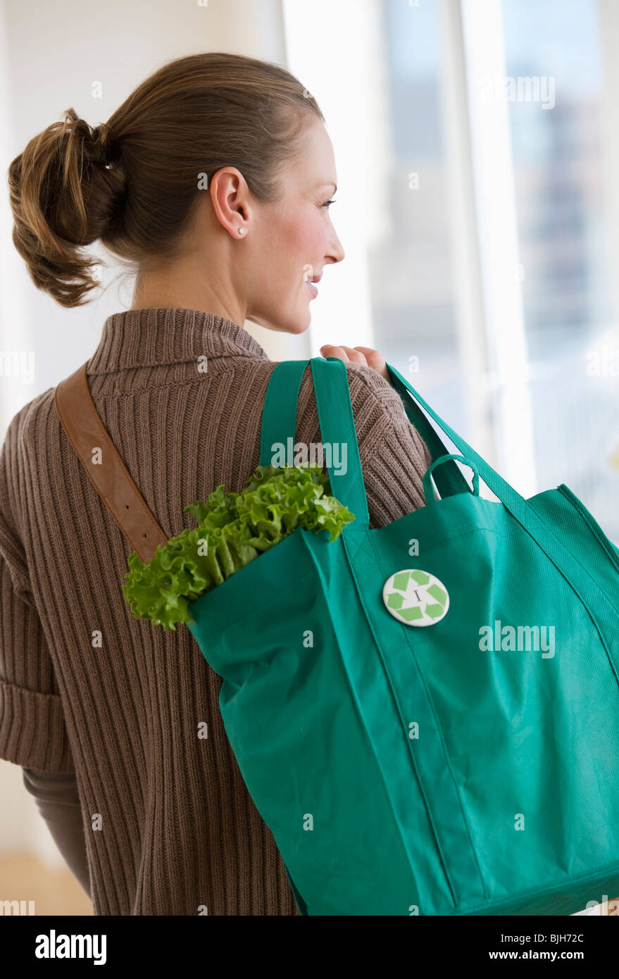 Woman carrying bag of groceries Stock Photo Alamy