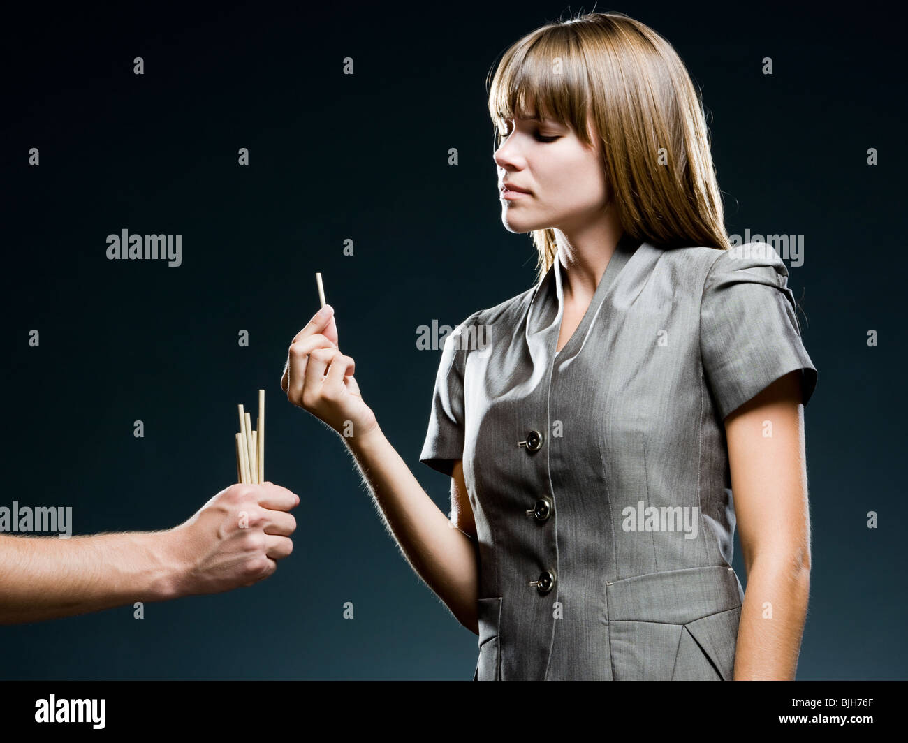 businesswoman drawing straws Stock Photo Alamy