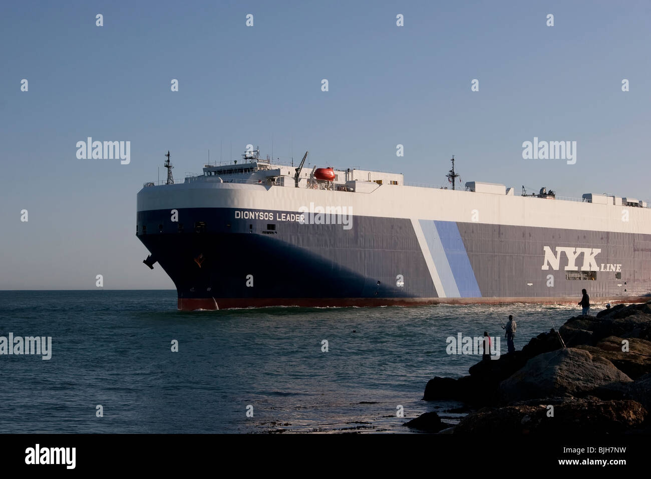 Cargo ship entering a harbor Stock Photo Alamy