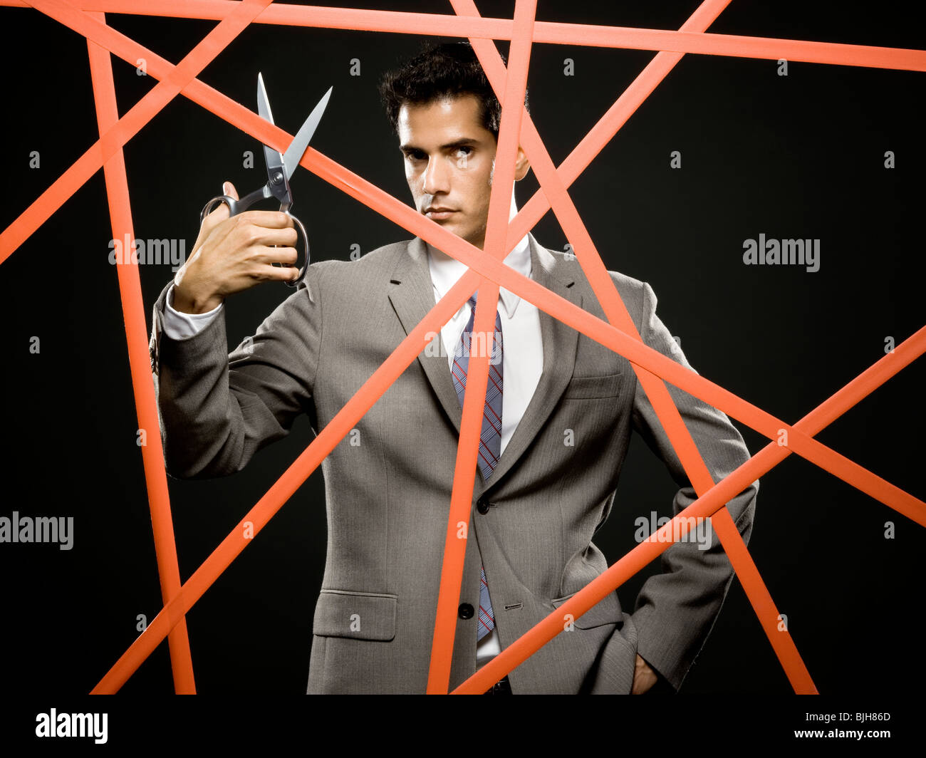businessman cutting through the red tape Stock Photo