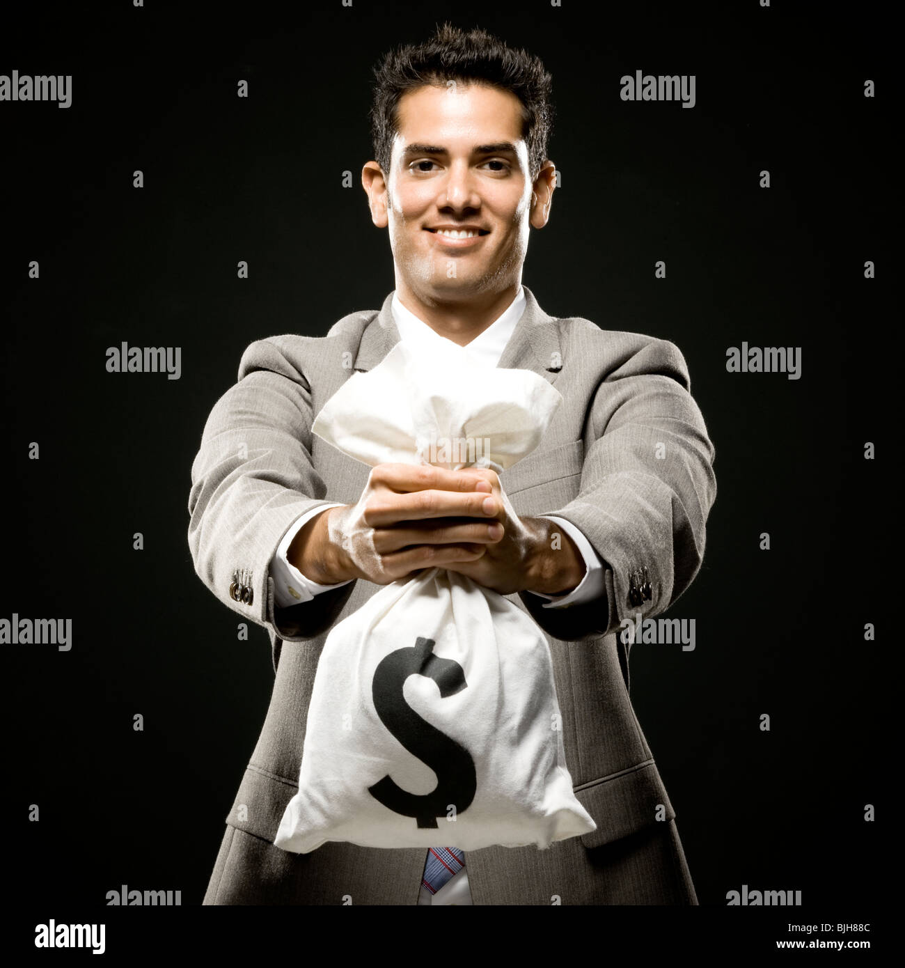 businessman holding a bag of money Stock Photo - Alamy