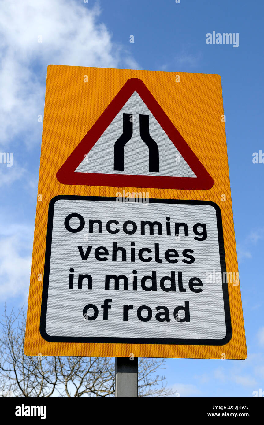 UK Road Sign 'warning oncoming vehicles in middle of road' Stock Photo