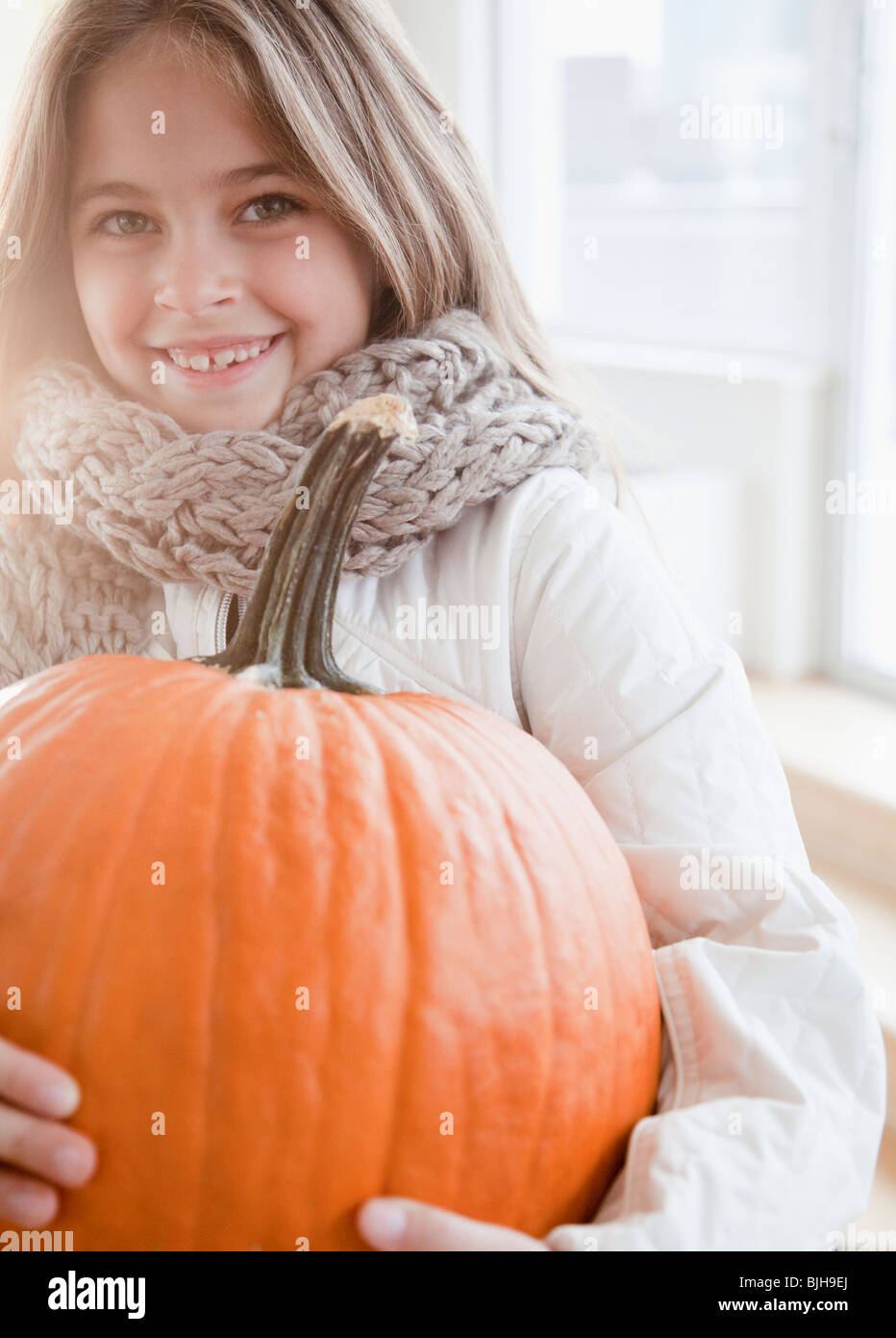 Young girl holding pumpkin Stock Photo - Alamy
