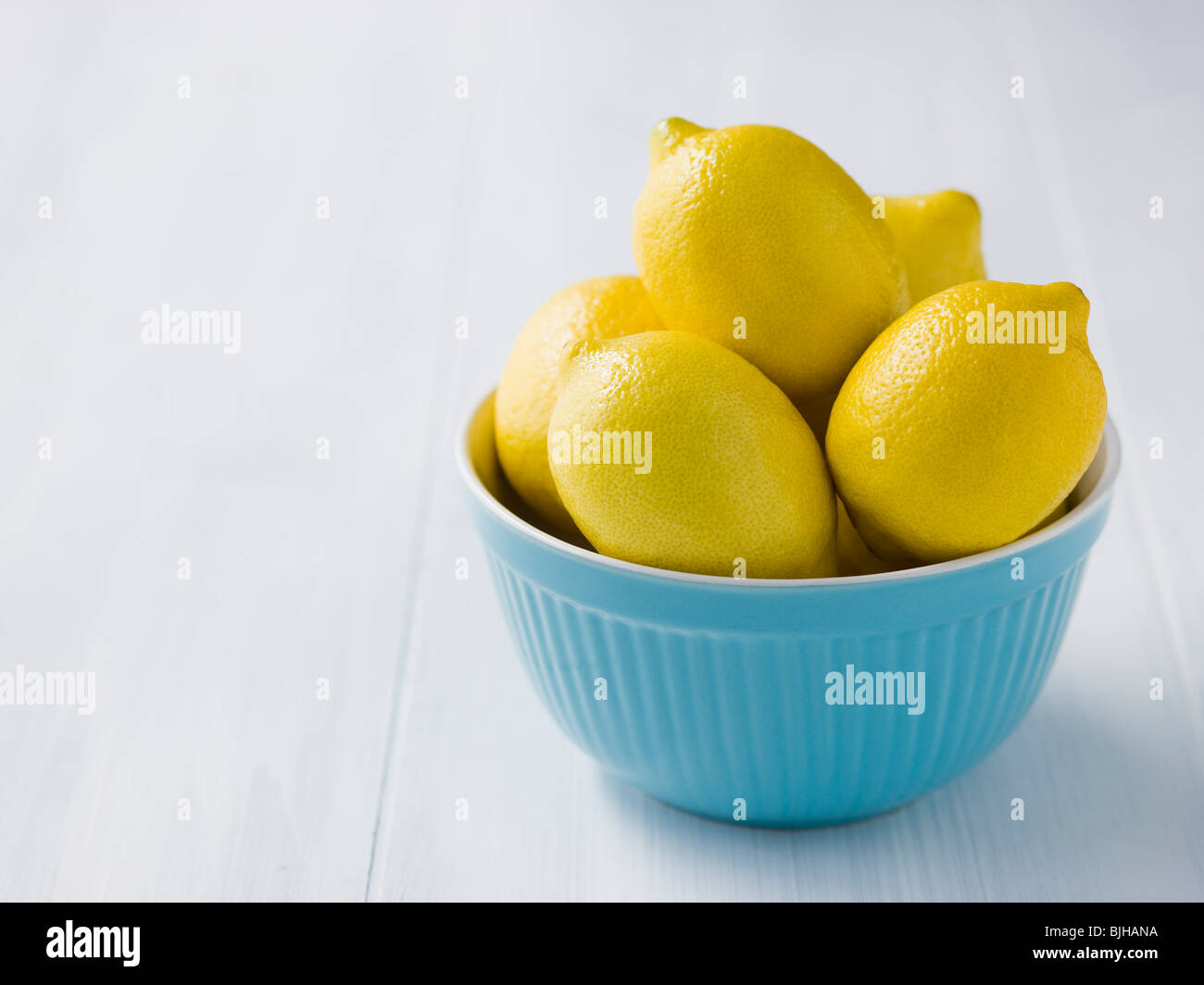 lemons in a blue bowl Stock Photo