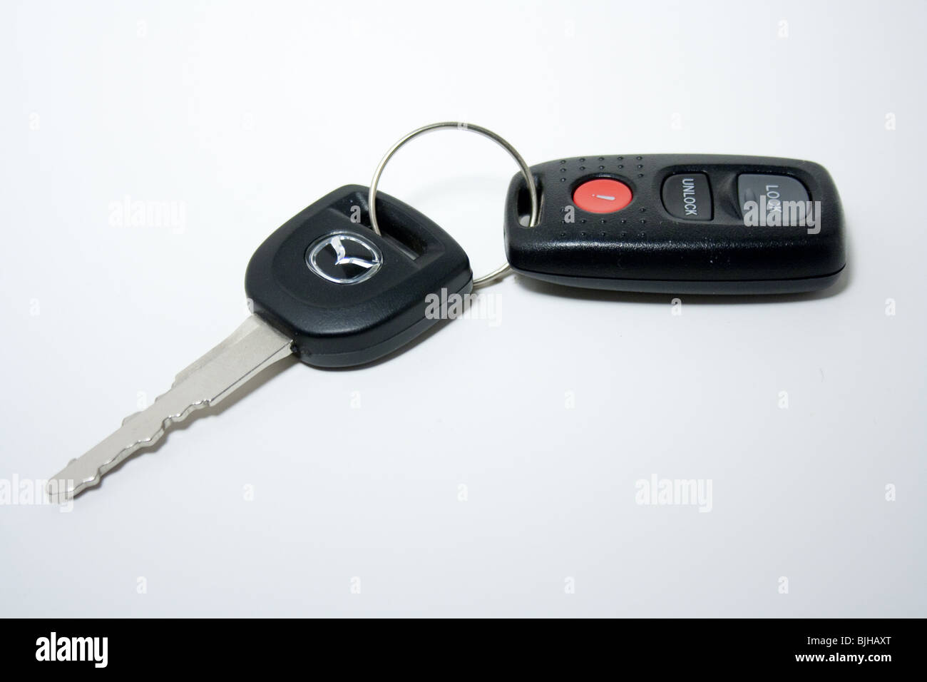 car key remote white background isolated panic lock unlock Mazda Japanese import sales Stock Photo