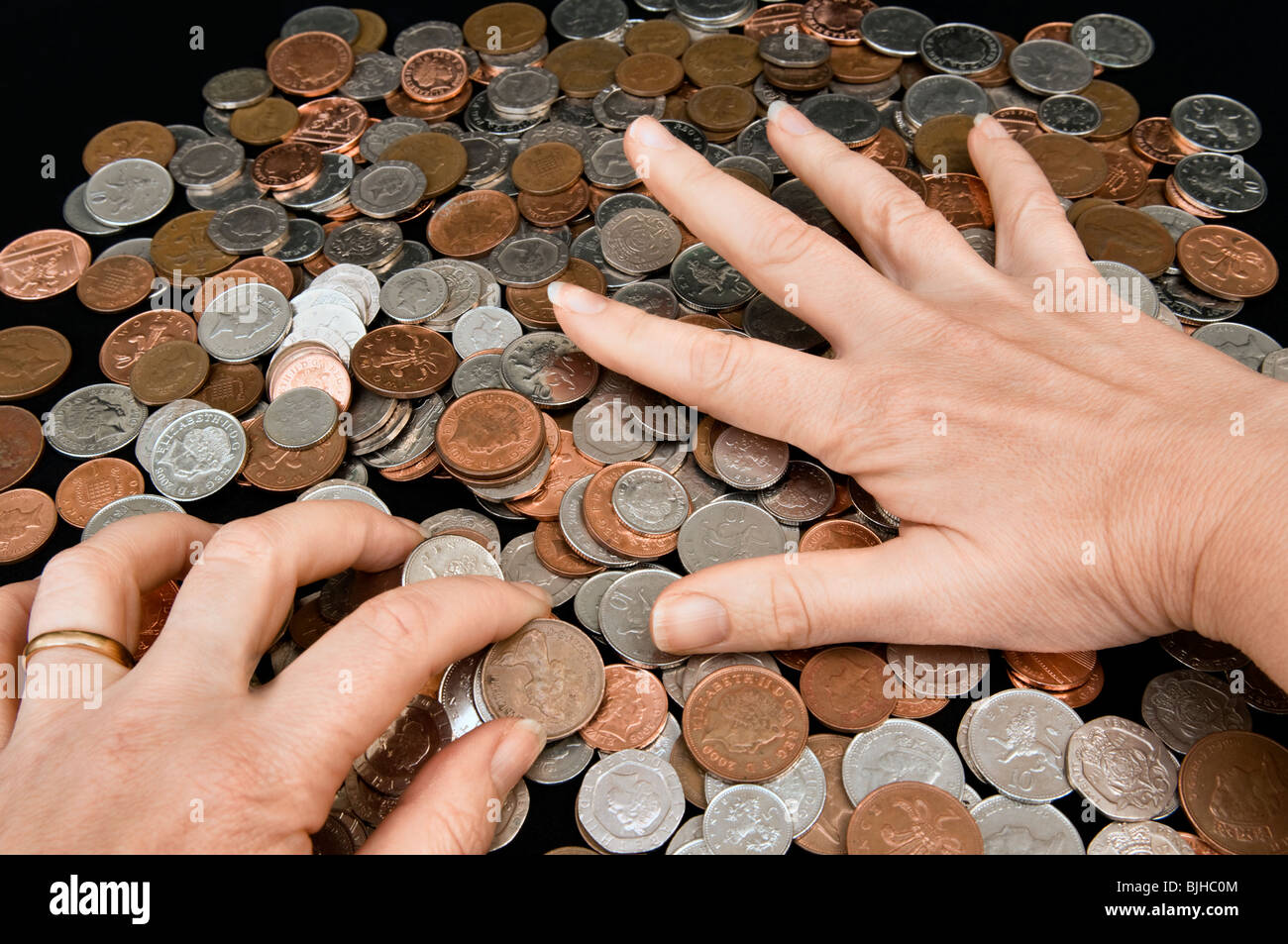 Caucasian womans hands grabbing money Stock Photo