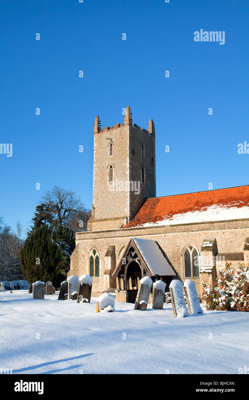 St Mary The Virgin's Church at Langham following Heavy Snowfall in the Essex countryside on a bright and vibrant winters day. Stock Photo