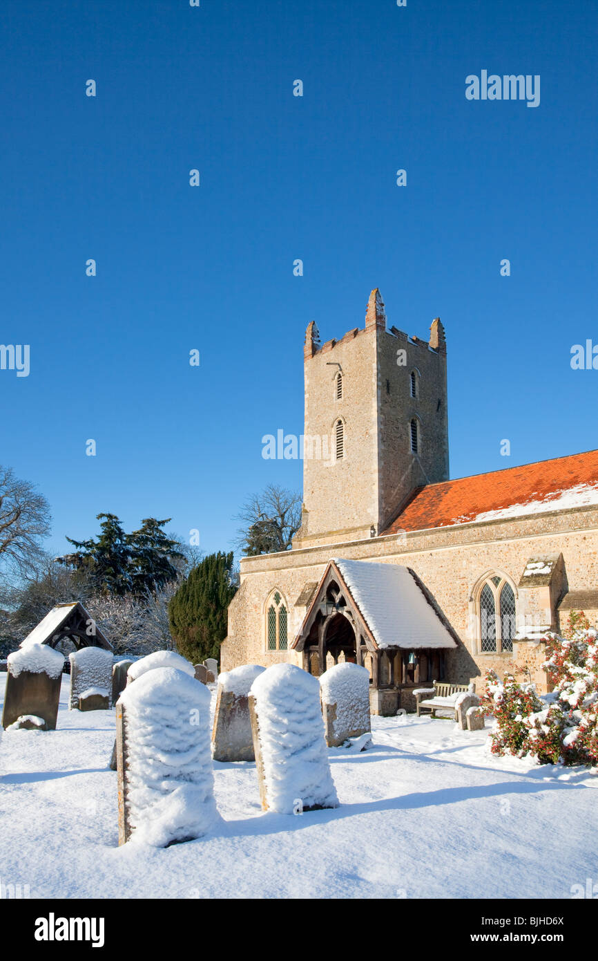 St Mary The Virgin's Church at Langham following Heavy Snowfall in the Essex countryside on a bright and vibrant winters day. Stock Photo