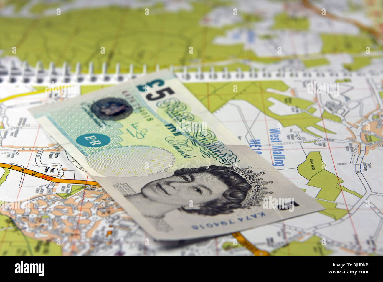 a £5 note on a the page of an open road map Stock Photo - Alamy