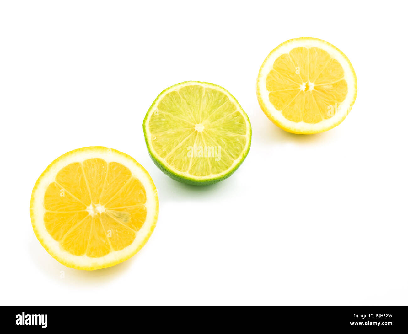 Two halves of lemon and half of lime on white background Stock Photo