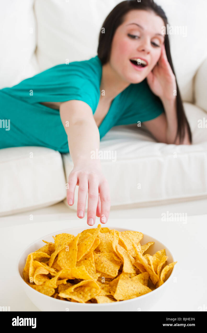 One woman junk food eating sofa hires stock photography and images Alamy