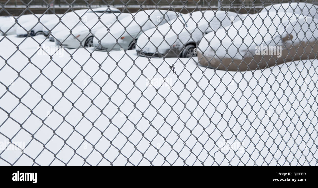 Parking lot behind chain link fence Stock Photo Alamy