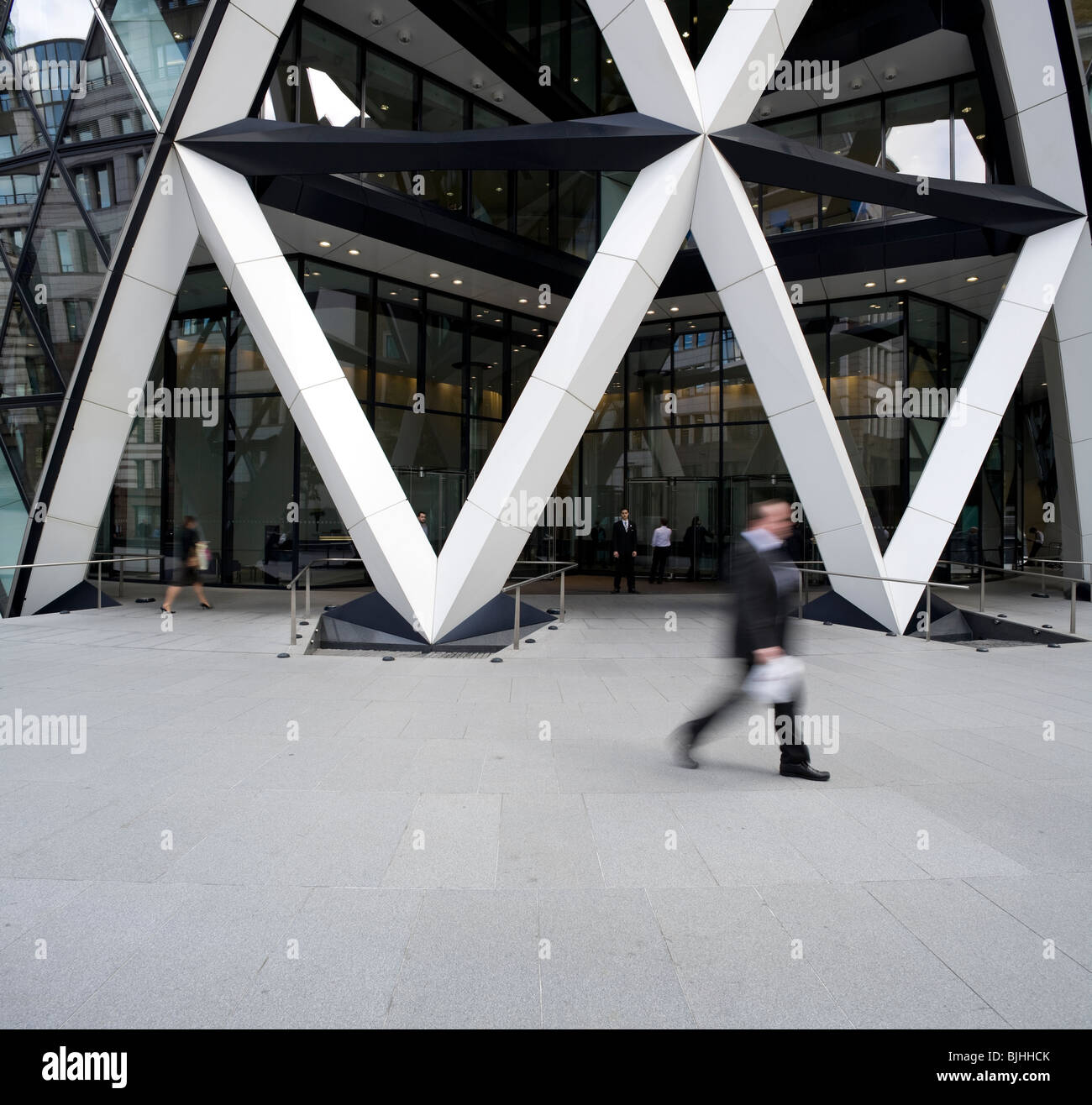 View of the Gherkin's main entrance and piazza at 30 St Mary Axe, showing the strong, white diagrid structured aperture. Stock Photo