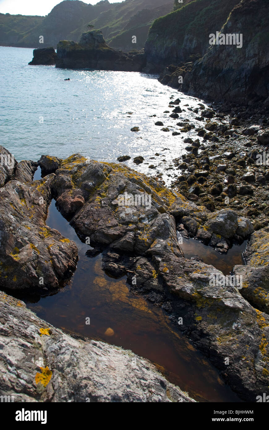 rocky coastline with rock pools jersey uk Stock Photo