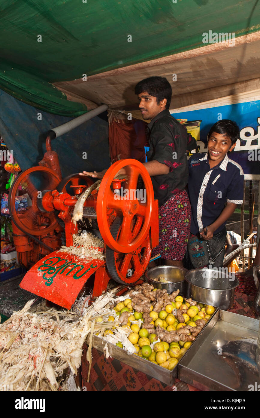 India, Kerala, Kanjiramattom Kodikuthu Moslem festival, men operating sugar cane press at cold drinks stall Stock Photo