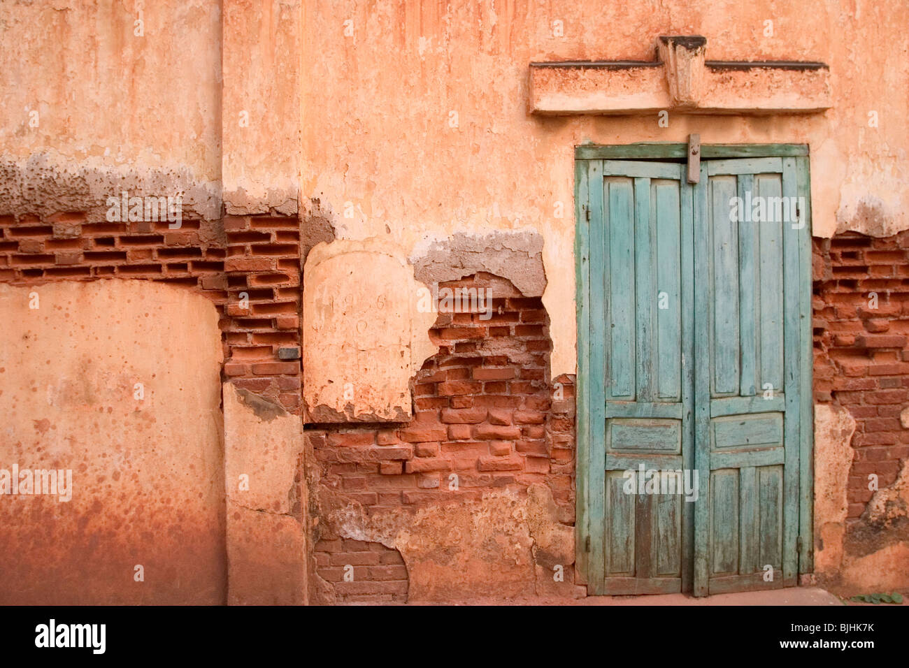 The wall and doors of an old French-era building in Savannakhet, Lao People's Democratic Republic. Stock Photo