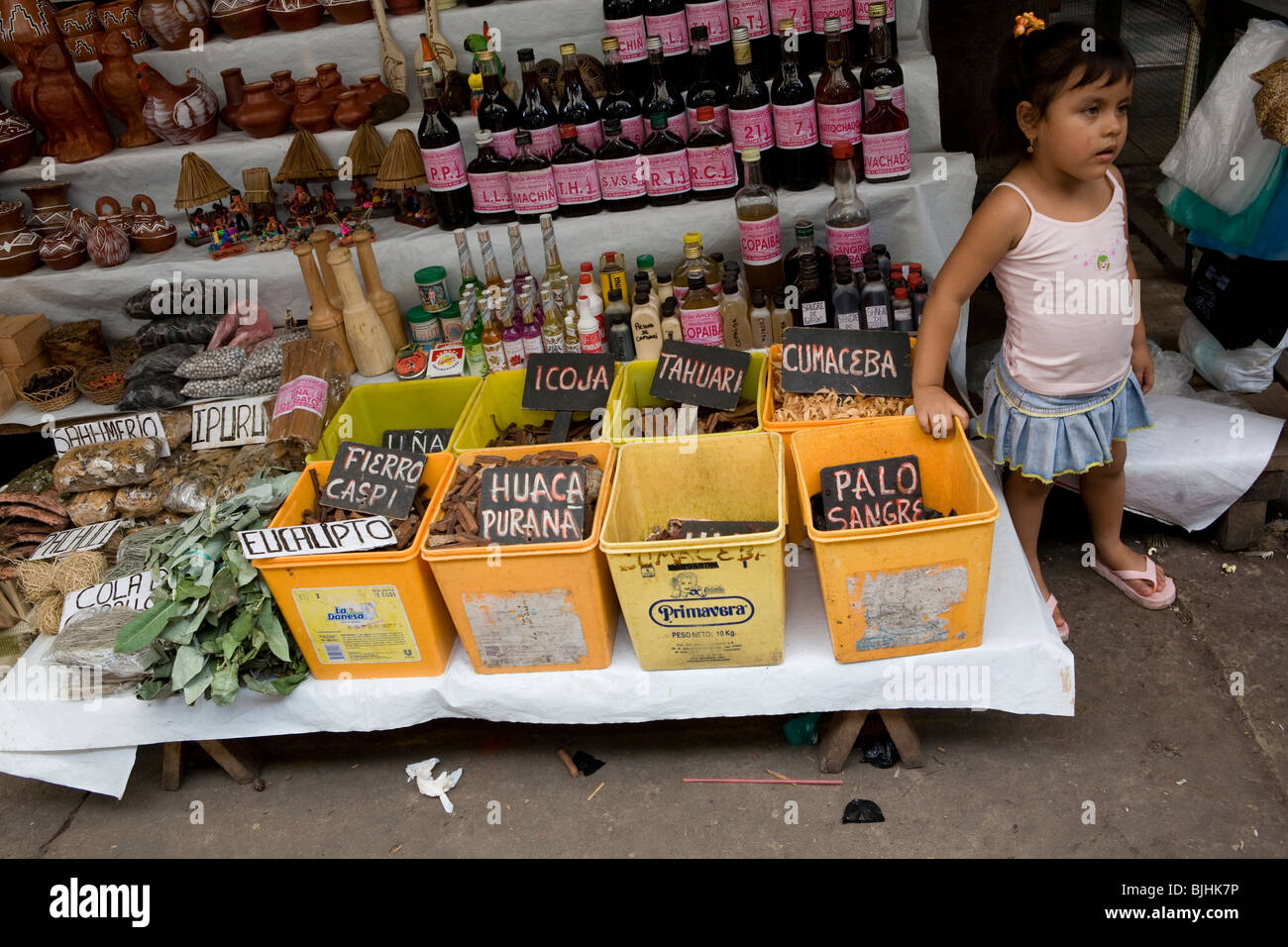 A girl outside a traditional medicine shop in Puerto Belen, Iquitos, in Peru's Amazon Basin. Stock Photo