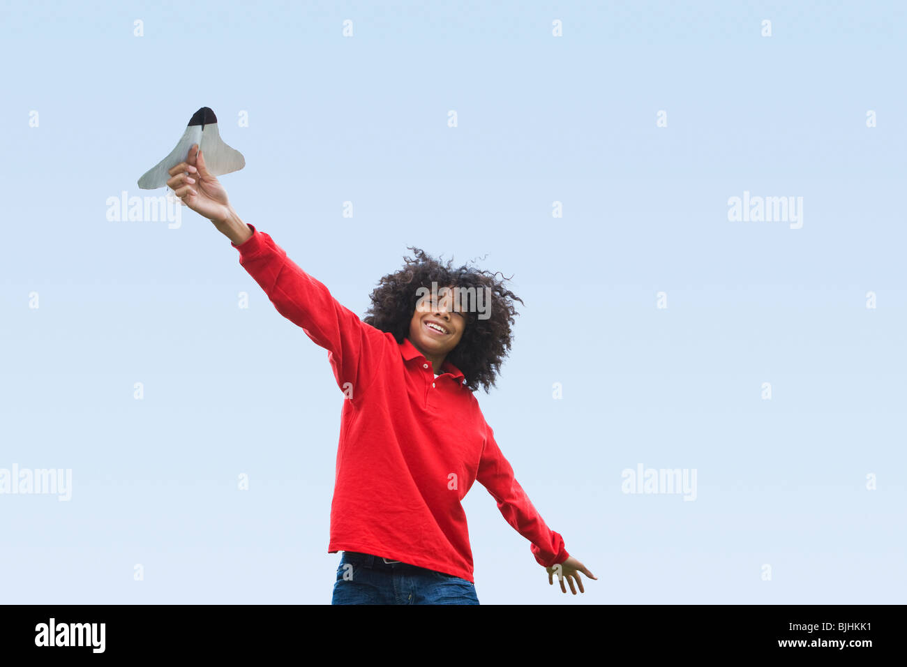 Woman flying toy plane Stock Photo