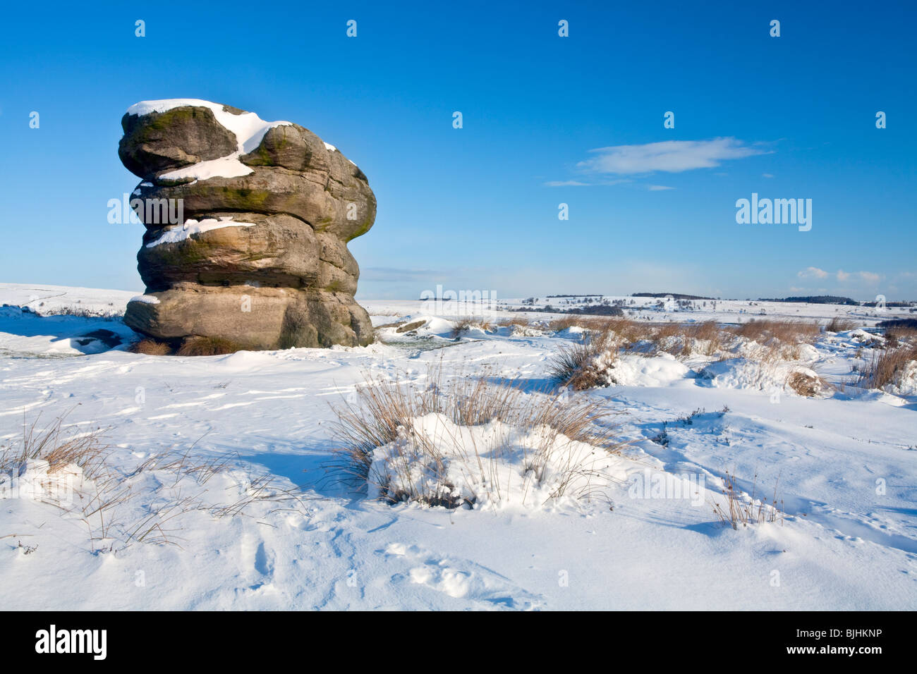 The Eagle Stone on Baslow Edge following heavy winter snowfall in the Peak District National Park Stock Photo