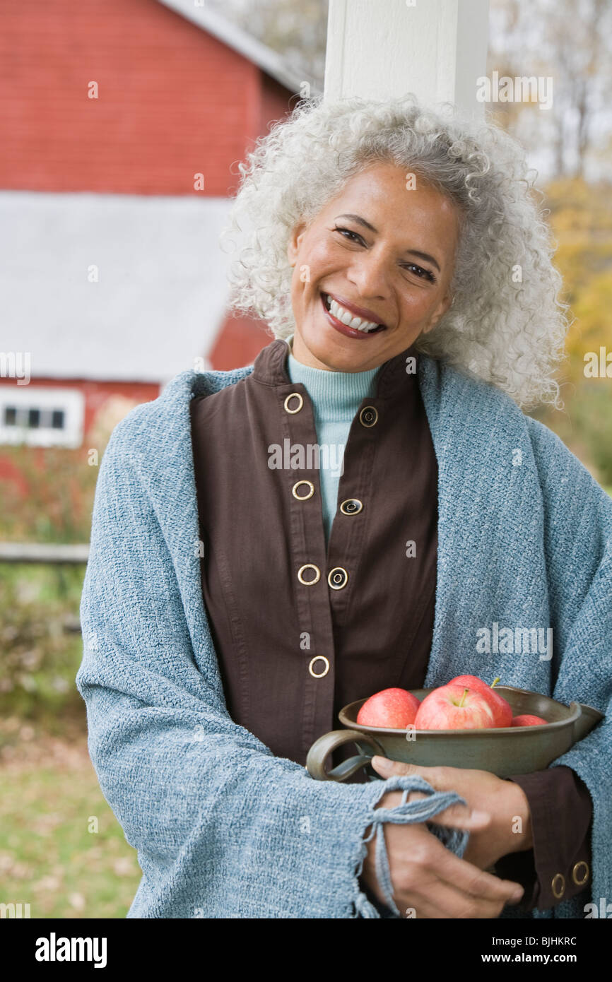 Woman holding bowl of apples Stock Photo