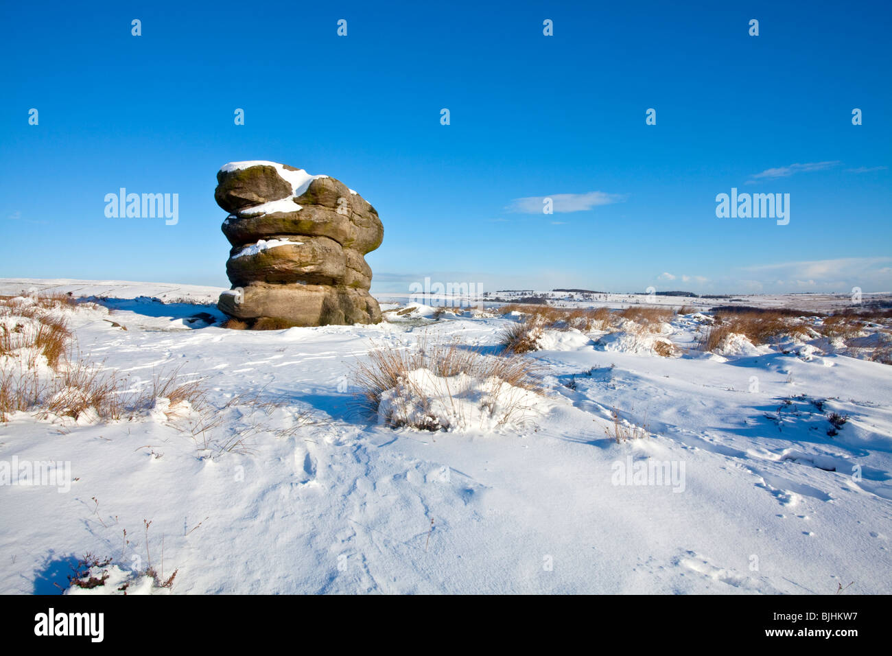 The Eagle Stone on Baslow Edge following heavy winter snowfall in the Peak District National Park Stock Photo