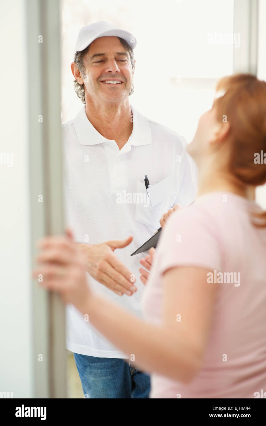 https://c8.alamy.com/comp/BJHM44/woman-talking-to-man-at-the-door-BJHM44.jpg