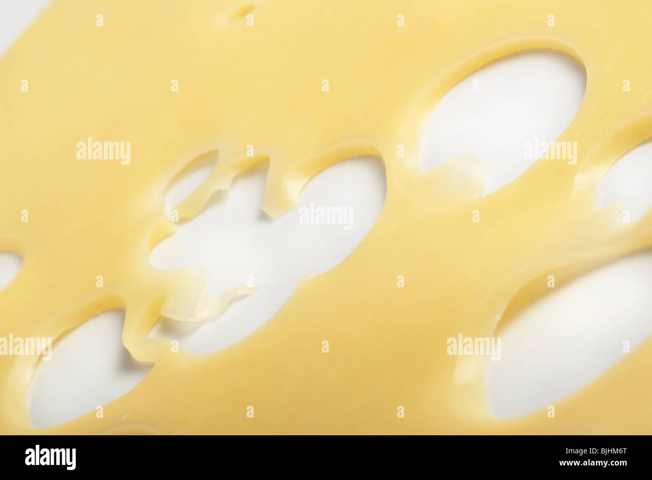 Close up of a slice of emmenthal cheese hires stock photography and