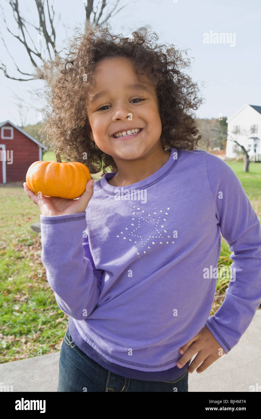 Young girl holding pumpkin Stock Photo