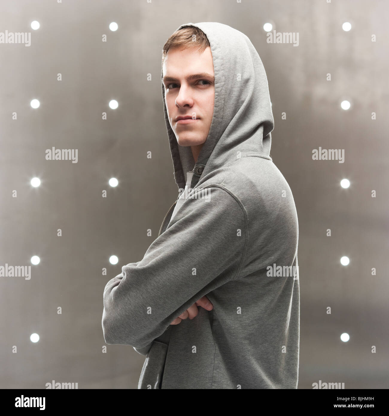 man in a hoodie with arms folded Stock Photo