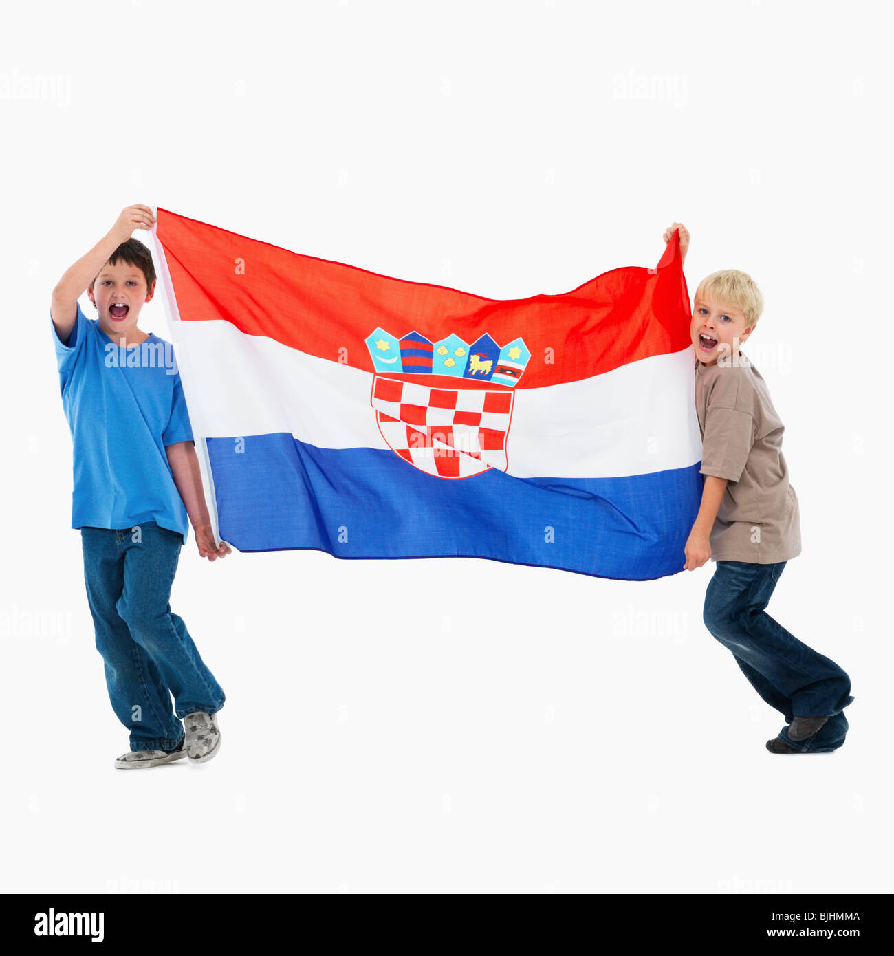 Two boys carrying flag Stock Photo