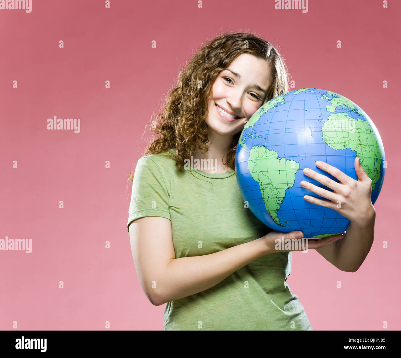 woman hugging a globe Stock Photo