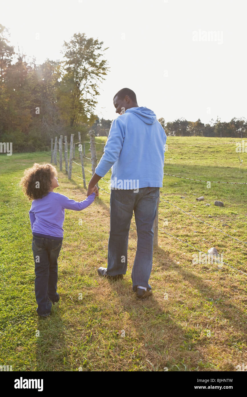 Father and daughter walking Stock Photo - Alamy